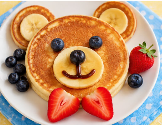 Teddy bear pancakes made with different size pancakes and fruit