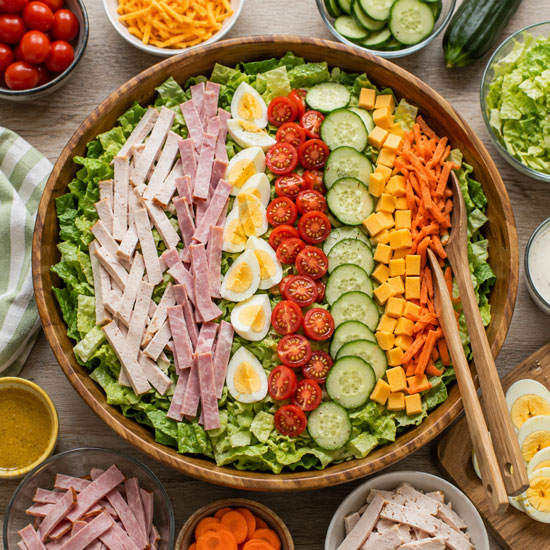 Chef salad with turkey ham eggs cheese tomatoes and lettuce