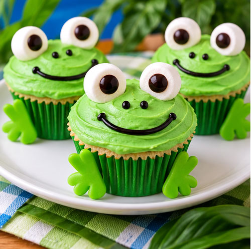 Green frog face cupcakes with candy eyes