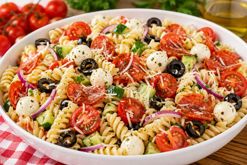 Classic Italian pasta salad with rotini pepperoni mozzarella tomatoes olives and Italian dressing