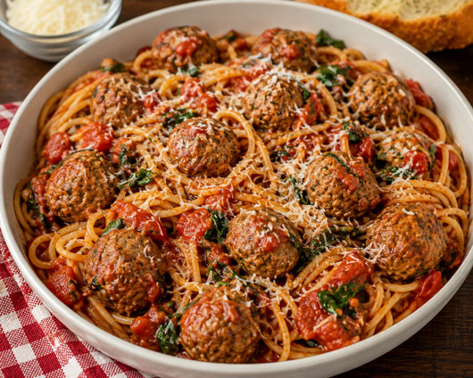 Meatballs Florentine with spaghetti, tomatoes and spinach