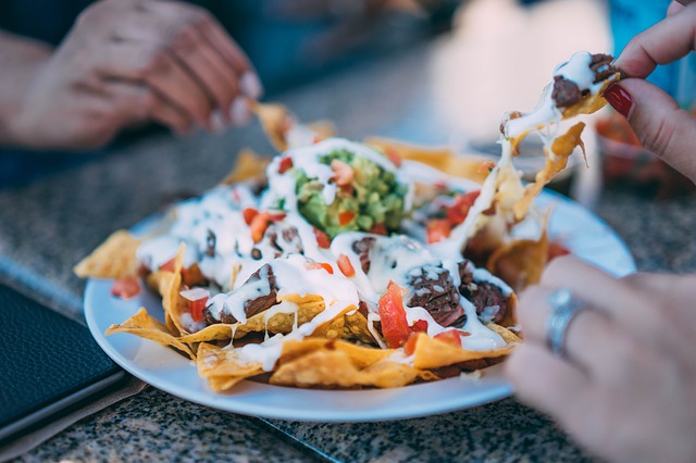 Easy nachos with cheese beans salsa and toppings