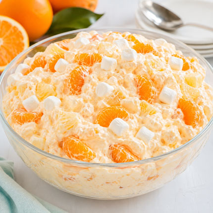 Orange fluff fruit salad with mandarin oranges pineapple marshmallows and creamy orange mixture