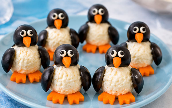 Mini cheese ball penguins decorated with olives and carrots