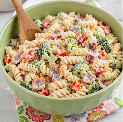 Creamy ranch pasta salad with vegetables bacon and cheddar cheese