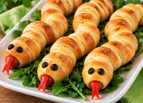Hot dogs wrapped in breadstick dough and decorated as snakes