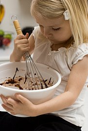 Child stirring batter in a bowl