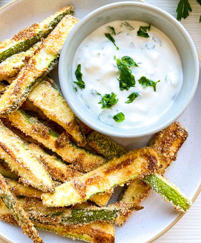 Baked Parmesan zucchini fries on a serving plate