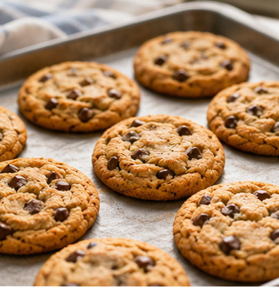 Chocolate chip cookies baking on a sheet pan