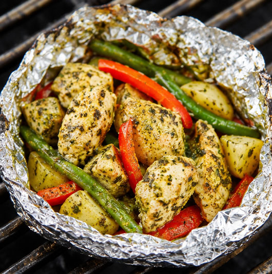 Chicken pesto foil packet with tomatoes and onion