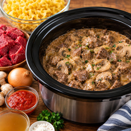 Crockpot mushroom beef stroganoff cooking in a slow cooker