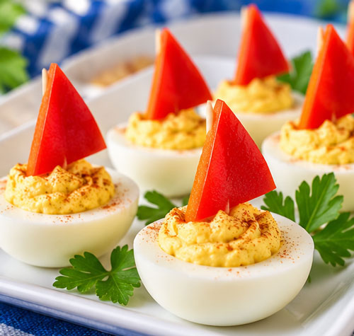 Deviled egg sailboats with red pepper sails