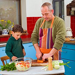 father with boy cooking