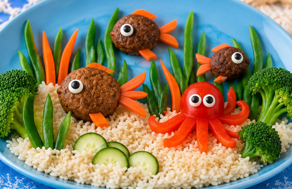 Edible under the sea dinner scene made with rice, meatballs and vegetables