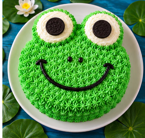 Green frog face cake with large cookie eyes