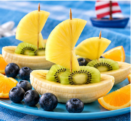 Fruit boats made with banana, kiwi and pineapple