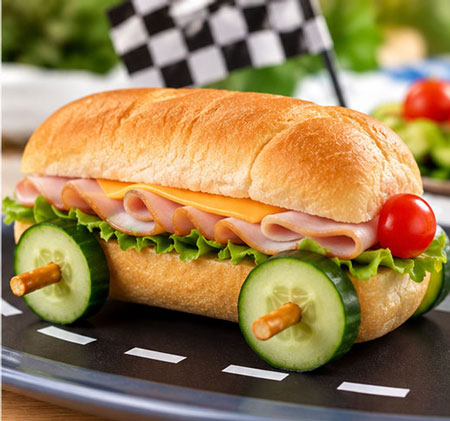 Hoagie sandwich made into a car with cucumber wheels