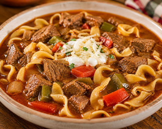 Hungarian steak soup with beef, peppers and egg noodles