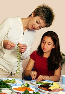 mom and girl preparing vegetables