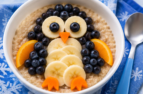 Penguin face made with oatmeal, berries and fruit