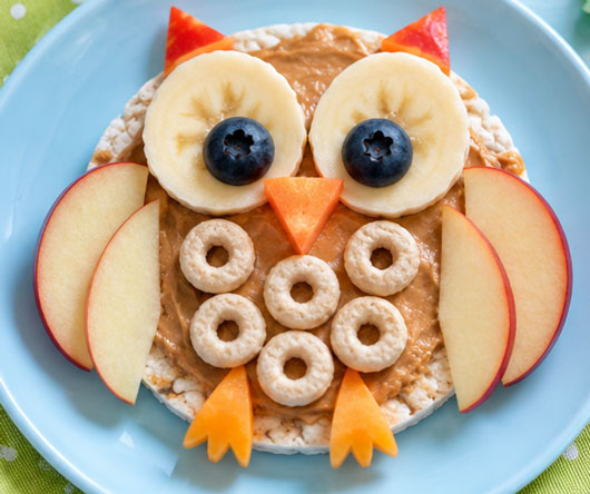 Rice cake owl decorated with fruit and cereal