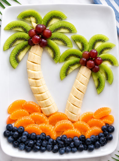 Fruit arranged on a plate to look like a palm tree