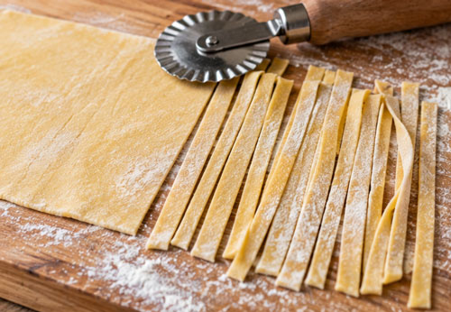 Making homemade pasta dough for an Italian cooking lesson