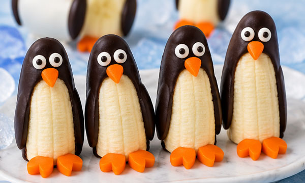 Banana penguins dipped in chocolate with candy eyes and orange beaks