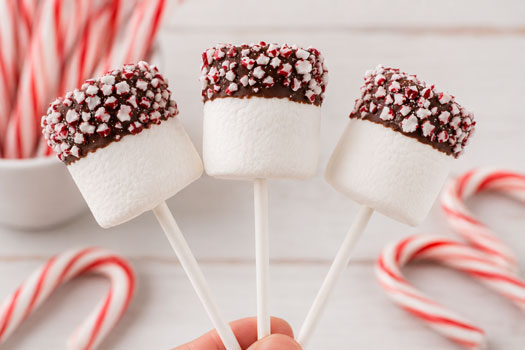 marshmallows dipped in chocolate and crushed candy canes