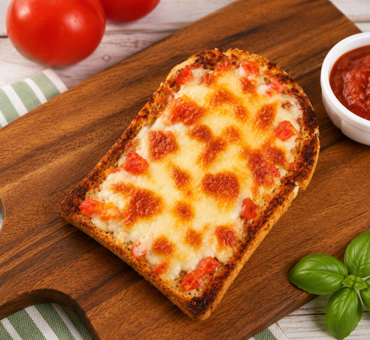 Pizza toast topped with sauce cheese and pizza toppings