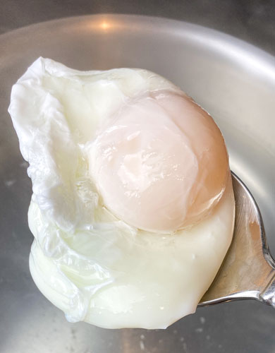 poached egg in boiling water