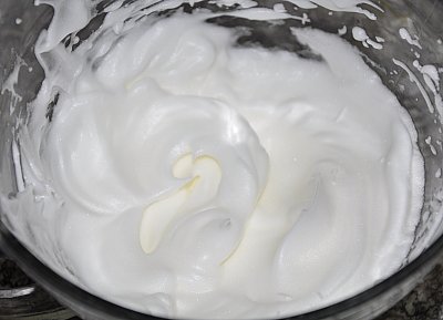 Beating egg whites into stiff peaks for meringue