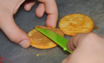 kids cooking lessons on spreading with a knife or spreader.