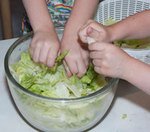 tearing lettuce and making a salad