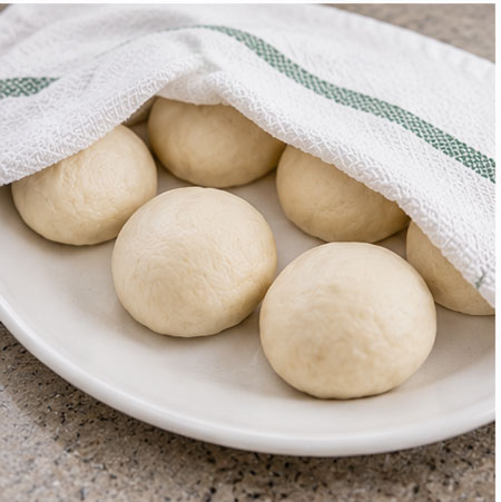 Homemade tortilla dough divided into balls