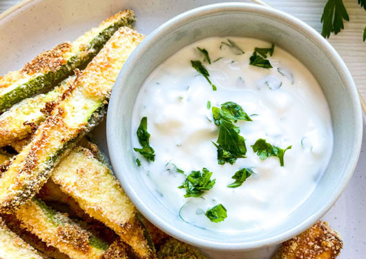 Baked Parmesan zucchini fries on a serving plate