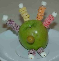 Turkey made out of an apple and cereal for feathers for kids Thanksgiving recipes