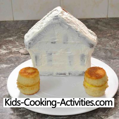 House cake pan baked and crumb coated waiting to become a little red barn.